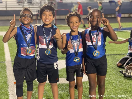 Blue Lightning 8U 4x100 relay Champions displaying their medals